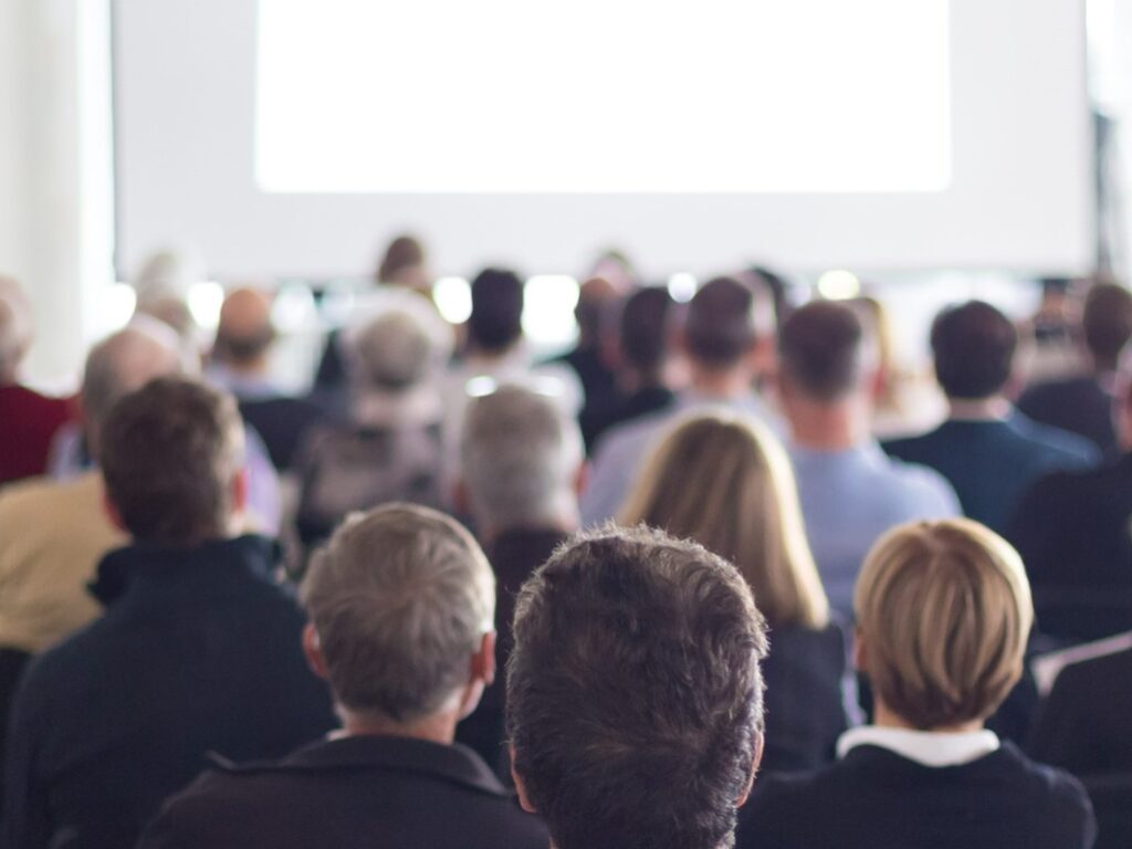 An audience receives a lecture